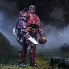 A GI Joe Cobra S.A.W. Viper action figure stands in a dark, foggy forest, holding a chainsaw
