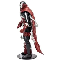 Side profile of the Spawn action figure, with a flowing red cape and chains.