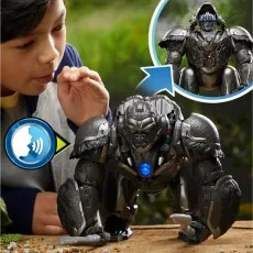 A boy plays with a transforming Optimus Primal toy that changes from gorilla to robot.