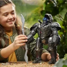 A smiling girl holds a translucent sword and plays with an Optimus Primal robot figure.