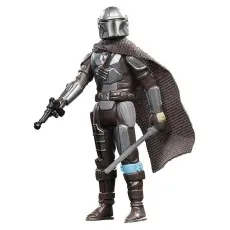 A Mandalorian action figure, standing with a blaster in one hand and a rifle in the other.