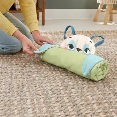 A person rolling up the panda-themed baby mat to store it, showing the light green underside