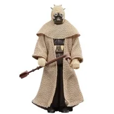 A Tusken Warrior action figure holding a Gaffi stick, wearing a textured beige robe and mask.