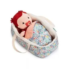A red-haired cloth doll with a pacifier lying snugly in a floral print, sherpa-lined toy doll carrycot