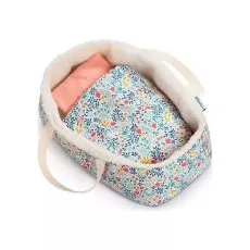 A toy doll carrycotMoses basket with a colorful floral pattern and a cream sherpa-like lining