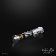 Hilt of Luke Skywalker's lightsaber, silver with gold and black accents, on a black background