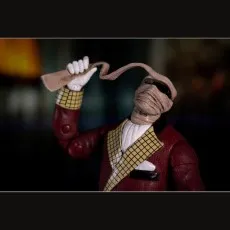 The Invisible Man toy figure in a red robe and white gloves, revealing his bandaged face.