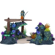 A detailed toy diorama of a coral reef with two figures and various colorful plants.