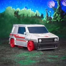 The Crosscut action figure as a futuristic car with red wheels and a red stripe, parked on a dark, textured surface.