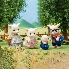 The four figures from the Sylvanian Families Goat Family set standing together in a grassy yard.