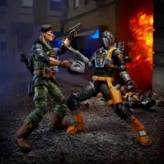 G.I. Joe action figures fighting in a diorama, with explosions in the background.