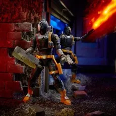 Two G.I. Joe B.A.T. action figures in a diorama, one holding a flamethrower.