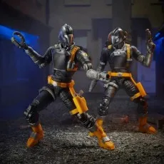 Two G.I. Joe B.A.T. figures stand posed in a dark alley setting.