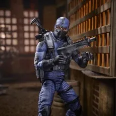 A G.I. Joe Cobra Officer action figure holding a submachine gun in a detailed diorama.