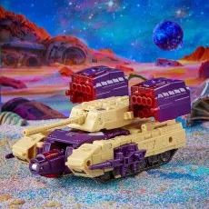 The Transformers Legacy Series Leader Blitzwing toy is in its tank form on a brightly colored alien planet.