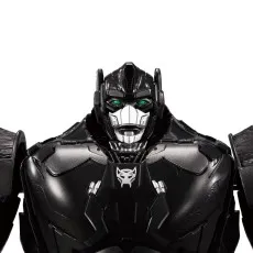 Close-up of Optimus Primal's robot face black helmet, silver mask, and glowing green eyes..
