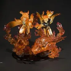 A statue of two Naruto figures (Minato and Naruto) in Nine-Tails Chakra Mode with vibrant orange flame effects.