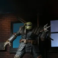 Close-up of The Last Ronin action figure with a bandana, holding a sai weapon in a dark alley diorama