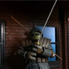 Close-up of the hooded Last Ronin action figure with an angry expression, drawing his katana in a dark alley