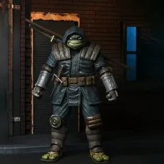 Full-body shot of The Last Ronin action figure in his dark, armored robe, standing with a katana strapped across his back