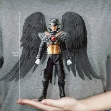 DAH-063 The Batman Who Laughs figure with large black wings held in a person's palm for size comparison.