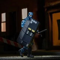 G.I. Joe Classified Series Shockwave figure in blue, wearing a riot helmet and holding a shield and baton in a dark alley.