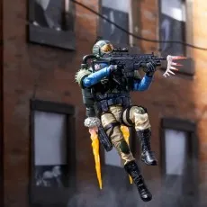 G.I. Joe Steel Corps Trooper figure leaping with a knife and submachine gun in a combat stance on an urban road.