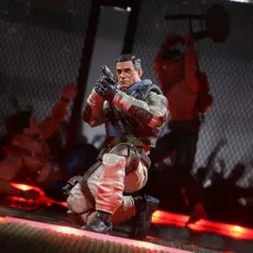 Airborne toy with helmet and gear, resting on a small blue stool in a dark, red-lit room.