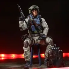 G.I. Joe Classified Airborne figure seated on a stool, holding a rifle and pistol, backpack nearb.