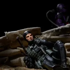 G.I. Joe-style action figure of a Recon Diver resting behind sandbags, holding a gun and a knife..