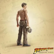 Hypnotized Indiana Jones action figure shown from behind, holding the Build An Artifact skull piece.