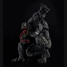 A highly detailed Venom statue in a menacing crouch, with tongue out and a clawed hand raised on a black background
