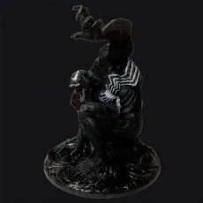 Detailed Venom statue crouches on a black base against a dark background, tongue out and one arm raised.