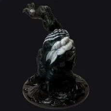 Rear view of the Venom statue on a dark background, showing the white back spider symbol and raised claw.