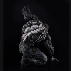 Side view of the Venom statue in a crouched position, emphasizing the white spider symbol on his back.