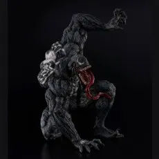Venom statue on a black background, snarling with sharp teeth and showing the white back spider symbol.