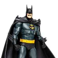 Close-up of a Batman action figure in a gray and black suit with a yellow belt, snarling expression, and large cape.