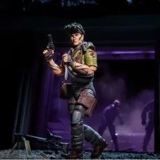 G.I. Joe Tunnel Rat figure holding a pistol and knife, with a large rifle on a bipod in the foreground.