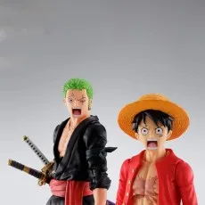 Close-up of One Piece Roronoa Zoro and Monkey D. Luffy figures with open-mouthed expressions.