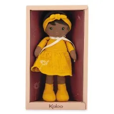 Kaloo fabric doll with brown skin and dark hair, wearing a mustard yellow dress and matching headband, in a box.