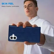 Close-up of a man holding the blue leather phone case with the camera cutout.