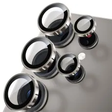Five titanium ring camera lens protectors being applied to a titanium grey smartphone