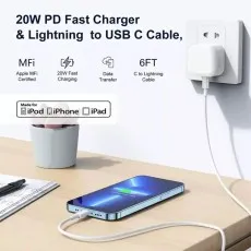 Apple 20W USB-C power adapter and 6ft cable charging a blue smartphone on a wooden desk.